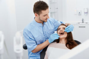 Dentist checking patient’s teeth gently
